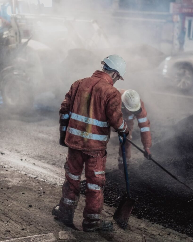 a man in a red uniform is using a shovel